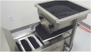 Multihead weigh filler dispensing particulates at the Minimus Products co-packing facility