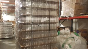 Empty bottles staged for filling and private-label packaging at Minimus Products