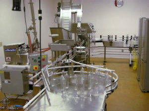 Liquid bottle filling line at Minimus Products contract packaging facility
