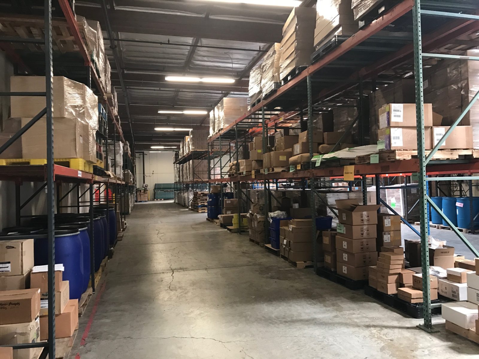 Warehouse racking and storage aisle at Minimus Products