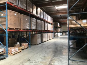 Warehouse storage aisle at the Minimus Products co-packing facility