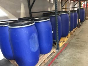 Bulk food ingredient drums staged in the Minimus Products warehouse